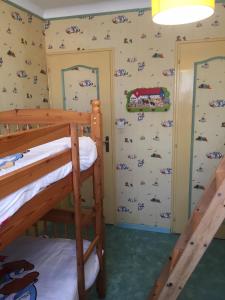 a bedroom with two bunk beds and a wall with stickers at Les Palmiers in Pornic +9 photos