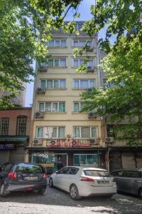 two cars parked in front of a tall building at Old City Park Hotel in Istanbul