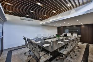 a conference room with a long table and chairs at Kavala Hotel in Bursa