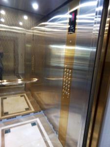 an elevator in a building with a glass window at Odessa Pearl Apartment in Odesa +20 photos
