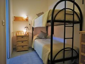 a bedroom with two bunk beds and a bed at Casa Vacanza NINA in Milazzo