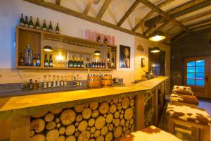 a bar with a bunch of wooden logs behind it at Staimicher Höhen - Premium Appartements in Kurort Steinbach-Hallenberg