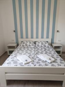 a bed in a bedroom with two night stands at Apartments 4you in Vir