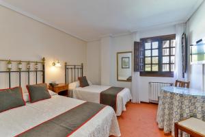 Llit o llits en una habitació de Hotel Santillana