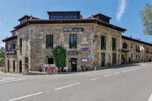 a building with a sign on the side of it at Hotel Santillana in Santillana del Mar