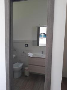 a bathroom with a sink and a toilet and a mirror at Valeri 's Country House in Sperlonga +35 photos