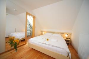 a bedroom with two beds and a mirror at Planinski dom Savica in Bohinj