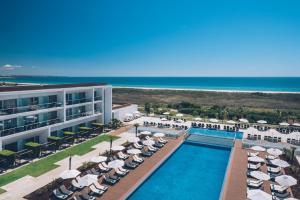 an aerial view of a resort with a swimming pool and beach at Iberostar Selection Lagos Algarve in Lagos