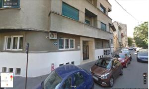 a group of cars parked in front of a building at Explore the City from Its Center in a Chic Balcony Apartment in Bucharest