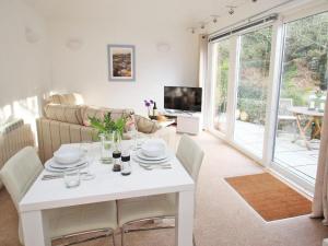 a living room with a white table and a couch at Cot Valley Cottage in St. Just