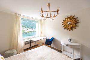 a bedroom with a window and a bed and a desk at Montreux & Leman View Apartment in Montreux