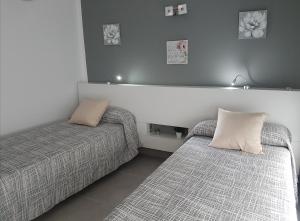 Łóżko lub łóżka w pokoju w obiekcie Vivienda Aries