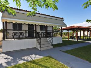 a house with a porch and stairs in a park at Mama's Twin Houses in Áyios Mámas +51 photos