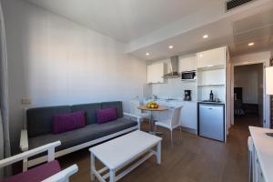 a living room and kitchen with a couch and a table at TC Apartamentos Don Diego in Playa del Ingles