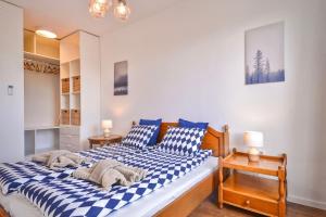 a bedroom with a blue and white checkered bed at South Park, Vitosha View, 2-BDR, 2-BTHR Apartment in Sofia
