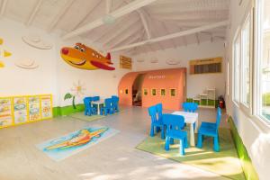 a classroom with a table and chairs and a plane at Serenity Bay Hotel - All Inclusive in Tsarevo