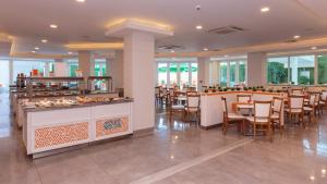 a restaurant with a buffet and tables and chairs at Serenity Bay Hotel - All Inclusive in Tsarevo