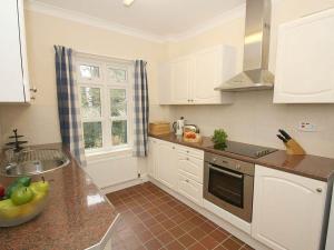 a kitchen with white cabinets and a counter top at Trelaze in Wadebridge