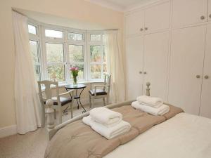 a bedroom with a bed with white towels on it at Trelaze in Wadebridge