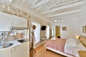 a bedroom with a bed and a sink in a room at Lela's House in Hydra