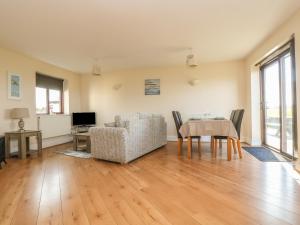 a living room with a table and a chair at Seabreeze in Marazion