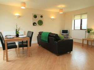 a living room with a couch and a table at Sail Boats in Marazion