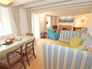 a living room with a couch and a table at White Duck Cottage in Hayle