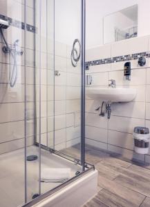 a bathroom with a glass shower and a sink at Hotel-Pension Mandy - Adults Only in Senftenberg +83 photos