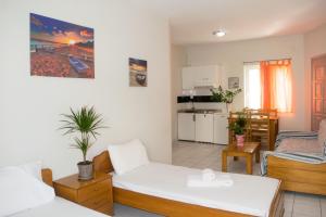 a living room with a couch and a kitchen at Greta Apartments in Hersonissos