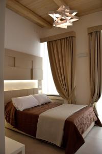 מיטה או מיטות בחדר ב-Le Suite del Duomo