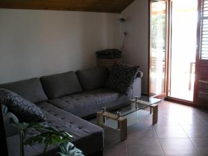 a living room with a couch and a coffee table at Apartments Ivo - sea view terrace in Veli Rat