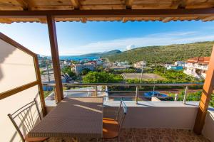 a balcony with a table and a view of a city at Villa Nertili in Ksamil