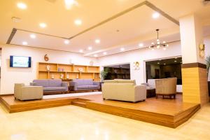 a lobby with couches and chairs in a building at Vivanta Chitwan Bharatpur in Bharatpur