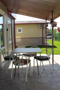 a table and two chairs on a patio at Guest House Valiland in Bŭlgarevo