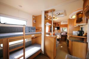 a small room with bunk beds in a trailer at Limnos Stone House in Kalliópi