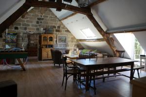 a dining room with a table and chairs in a attic at Domaine de Migoule in Brive-la-Gaillarde