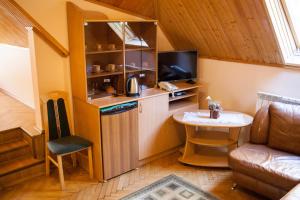 a living room with a kitchen and a small table at Goverla in Yaremche