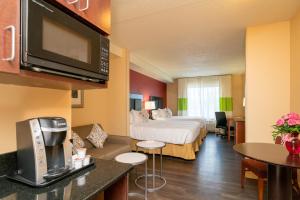 a large hotel room with a bed and a kitchen at Hotel Arboretum in Washington