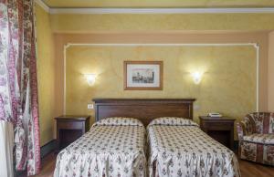 Postel nebo postele na pokoji v ubytování Hotel Minerva Palace