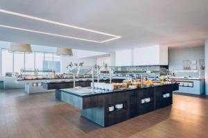a large kitchen with a bunch of food on display at Iberostar Selection Lagos Algarve in Lagos