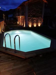 a swimming pool at night with lights at B&B da Morena in Gorfigliano