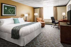 a hotel room with a large bed and a desk at Lakeview Golf Resort in Morgantown +88 photos