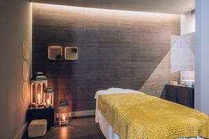 a bedroom with a bed with a yellow blanket at Iberostar Selection Lagos Algarve in Lagos