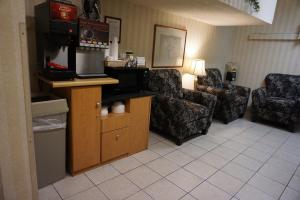 a living room with a couch and a chair at CenterWay Hotel Buffalo North Near University in Tonawanda