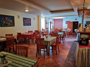 a restaurant with tables and chairs in a room at Penzión Helios in Bratislava