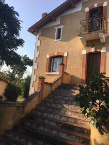 una casa con escaleras que conducen a un edificio en Le Clos de la Gravette, en Bessières