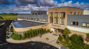 an overhead view of a building with a swimming pool at Diamond Coast Hotel in Enniscrone