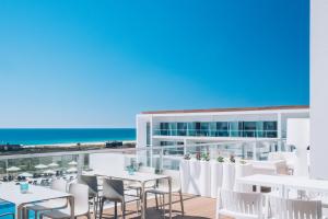 a view of the balcony of a hotel with tables and chairs at Iberostar Selection Lagos Algarve in Lagos