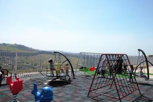 a playground with play equipment and people playing on it at Sindyan Resort in Amman