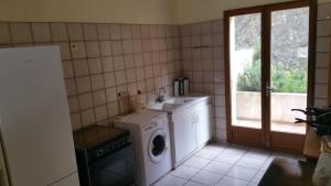 a kitchen with a washing machine and a sink at cerbere terrimbo in Cerbère